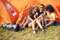 People, music festival and drinks by tent, excited and relax wellness in nature with friends. Men, woman or happy at