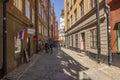 People on narrow cobbled streets of Stockholm\'s old town area.