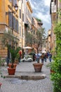 People on the narrow picturesque street in Rome, Italy
