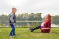 Family and nature concept - Mother and her child playing with colorful soap bubbles Royalty Free Stock Photo