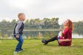 Family and nature concept - Mother and her child playing with colorful soap bubbles Royalty Free Stock Photo