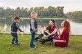 Family and nature concept - Mother, father and their children playing with colorful soap bubbles Royalty Free Stock Photo