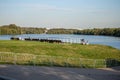 People on the nature. little girl having a picnic with little brother in a stroller on the river bank in the park. Royalty Free Stock Photo