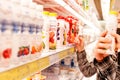 People near the dairy department in the supermarket few days before war in Ukraine