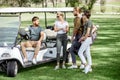 People near the golf car on the playing course Royalty Free Stock Photo