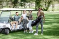 People near the golf car on the playing course Royalty Free Stock Photo