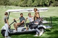 People near the golf car on the playing course Royalty Free Stock Photo