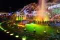 People are near light-musical fountain in shopping and entertainment complex Soho Square in evening, Sharm El Sheikh, Egypt