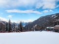 People near ski lift and slopes in the mountains of winter resort, French Alps