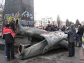 People near thrown big bronze monument to Lenin Royalty Free Stock Photo