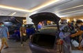 People with new electric vehicle cars in showroom of Shopping center Bangkok