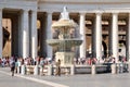 People next to a fountain at Saint Peter`s Square at the Vatican Royalty Free Stock Photo