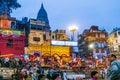 people in the night celebrate in Varanasi a religious washing ceremony