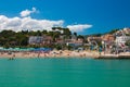 People on the Numana beach and the city in the Marche region Royalty Free Stock Photo