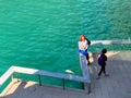 People observe a giant carp that is floating belly up on the Chicago River during evening commute