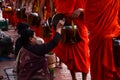 People offer food to monks