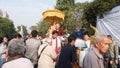 people offering food and items to a buddhist monk and being blessed in temple