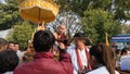people offering food and items to a buddhist monk and being blessed in temple