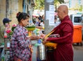 People offering foods to Buddhist monks in Myanmar