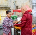 People offering foods to Buddhist monks in Myanmar