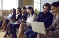 People in office at business meeting sitting on chairs with laptops and notebooks. Royalty Free Stock Photo