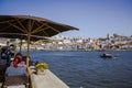People at Outdoor cafes at historic Ribeira of Porto