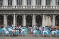 People in outdoor seating of a cafe in Saint Mark`s square in Venice, Italy Royalty Free Stock Photo