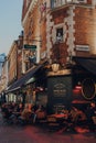 People at the outdoor tables of Shakespeares Head pub in Soho, London, UK