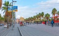 People outdoors, in rickshaw, on bicycles & walking about, taking advantage of warm weather on a concourse above tunnel traffic. Royalty Free Stock Photo