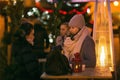 People outdoors sipping christmas punch on Christmas Eve.