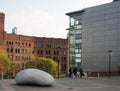 People outside the bridgewater hall concert venue in manchester city centre with the ishinki touchstone sculpture outside the Royalty Free Stock Photo