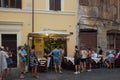 Rome, Italy: People outside Da Enzo Al 29, a popular local restaurant along a cobblestone street in charming Trastevere.