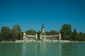 People paddling boats on pool in a park of Madrid