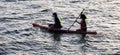 People paddling on inflatable rubber rafts in the river