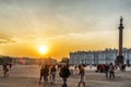 People on Palace Square at Hermitage and Alexander Column at sunset