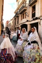 People parading in regional costumes in procession in Elche Royalty Free Stock Photo