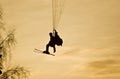 People on paraplane at sunset