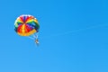 People parascending on parachute in blue sky Royalty Free Stock Photo