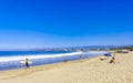 People parasols sun loungers beach waves palms Zicatela Mexico