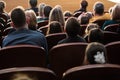 People, parents with children in the audience watching a children`s show. Sold out. Shooting from the back