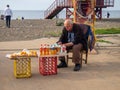 People in the park. Batumi boulevard. Tourist place. A man sells homemade wine and lemons. Sale on the street