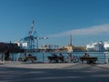 People on park benches in front of port of Genova with lantern view