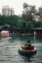 people at the park playing with small floating dinghy vehicles at the afternoon Royalty Free Stock Photo