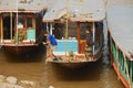 People park traditional long boats at the bank of Mekong river in dry season in Luang Prabang, Laos.