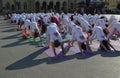 People participate in a yoga event in the center of the city