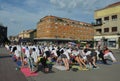 People participate in a yoga event in the center of the city