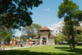 People pass entrance gate to the Temple of the Tooth Sri Dalada Maligawa in Kandy, Sri Lanka. Royalty Free Stock Photo