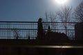 people passing on a bridge with sun and blue sky above Royalty Free Stock Photo