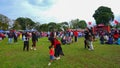 People passing by on the green field, at the health walk festival