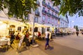 People passing by open cafÃÂ© terraces in Lisbon